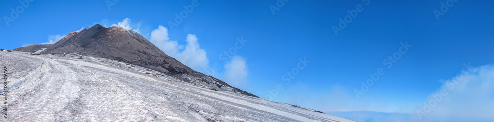 smoke around mount etna crater in winter