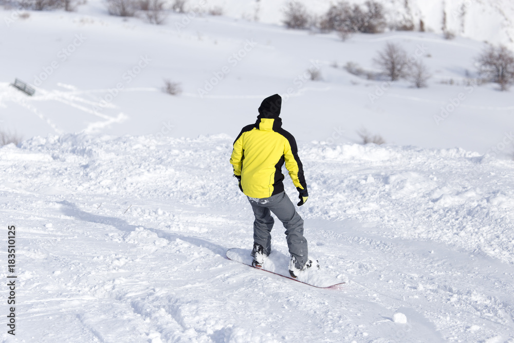 Man is snowboarding in the snow in winter