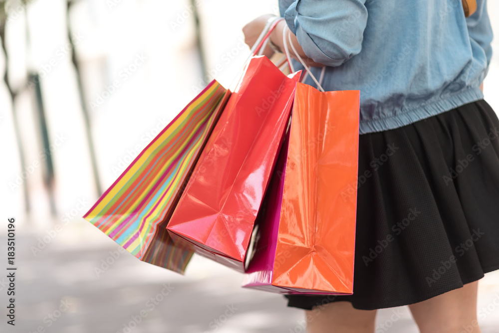 Woman walking and holding shopping bags Woman walking and holding shopping bags