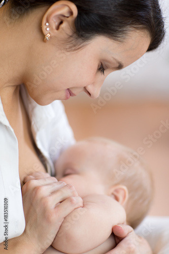 young mother breast feeding...