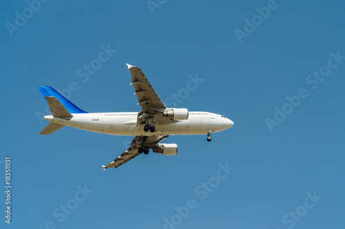 Passenger Airplane Flying On Clear Blue Sky