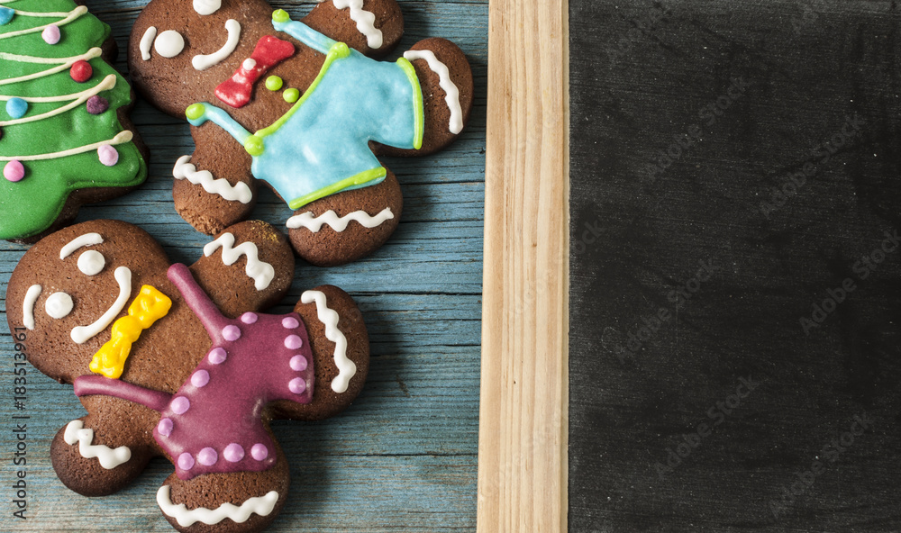 Christmas gingerbread cookies on old wooden background