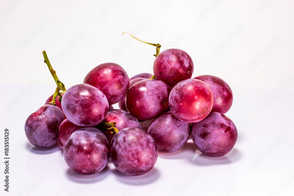 Red grapes cooked on white back ground.