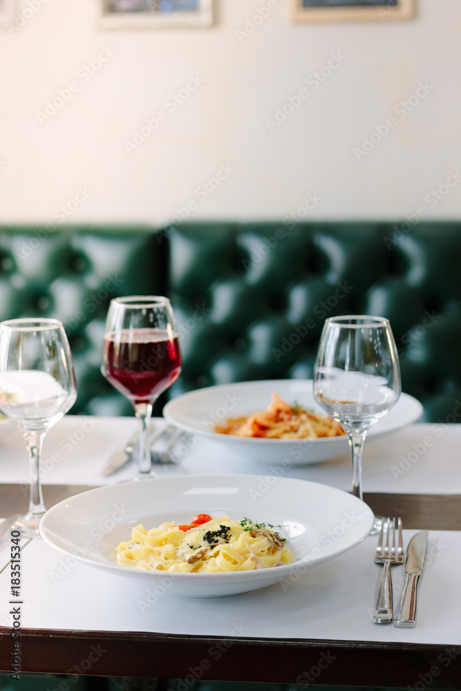 Traditional fettuccine pasta with mushrooms at italian restaurant. Traditional fettuccine pasta with mushrooms at italian restaurant.