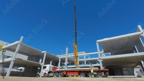 Construction Workers Unloding Pre Fabricated Slabs of Concrete Off A Huge Lorry