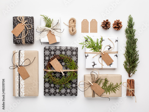 Handmade wrapped christmas gift boxes on white background. Top view, flat lay.
