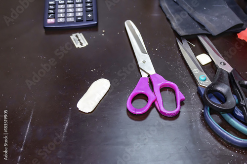 Scissors on the workplace of a seamstress. photo