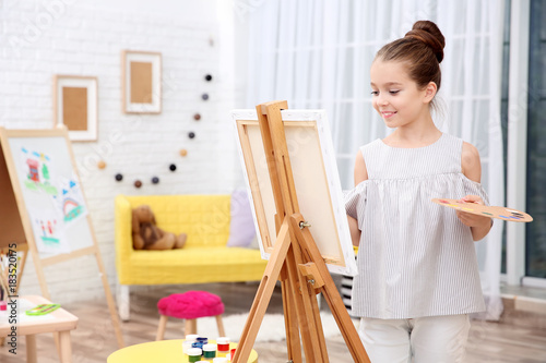 Little girl painting at home