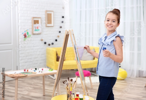 Little girl painting at home