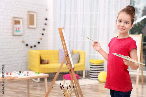 Little girl painting at home