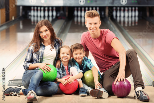 Family having fun in bowlin...