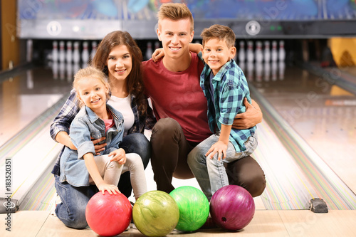 Family having fun in bowlin...