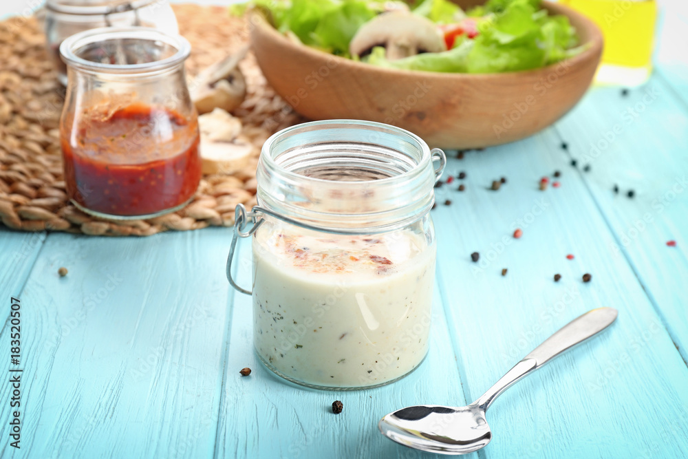 Glass jar with ranch salad dressing on table Glass jar with ranch salad dressing on table