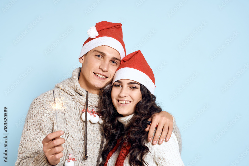 a man holds a Bengal fire in his hand and hugs a woman, a smile, a new year, a holiday, a couple a man holds a Bengal fire in his hand and hugs a woman, a smile, a new year, a holiday, a couple