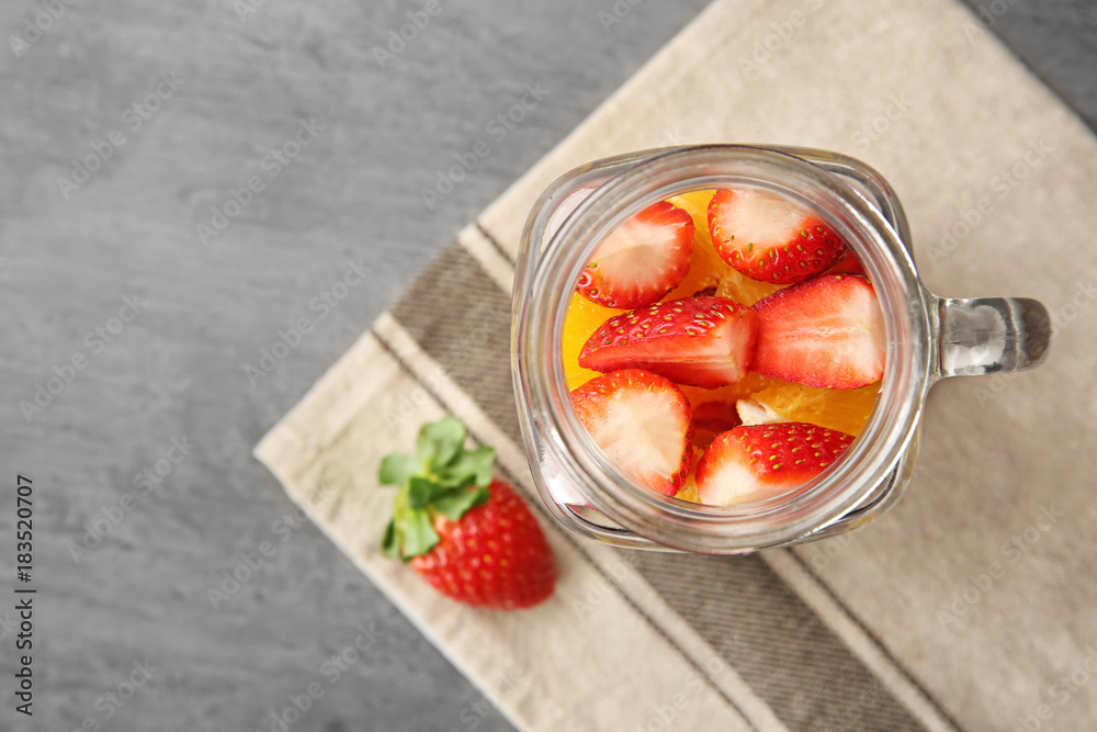 Delicious fruit salad in mason jar on table Delicious fruit salad in mason jar on table