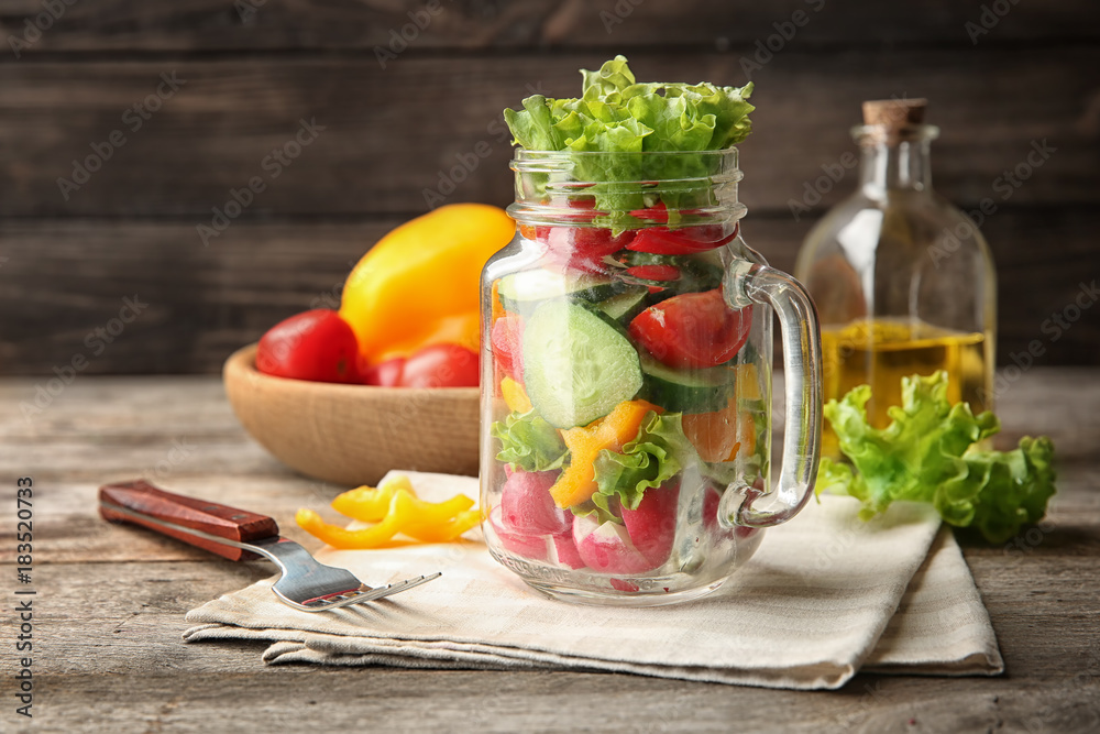 Delicious vegetable salad in mason jar on table Delicious vegetable salad in mason jar on table