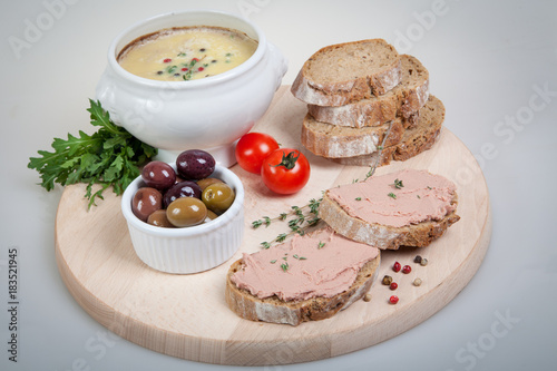 plate with slices of bread with home made pate, decorated with vegetables