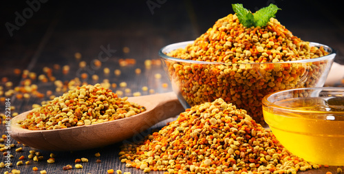 Bowls with bee pollen and honey on kitchen table