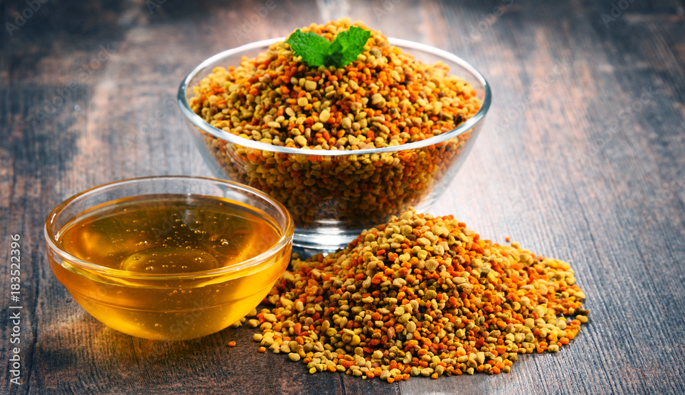 Bowls with bee pollen and honey on kitchen table Bowls with bee pollen and honey on kitchen table