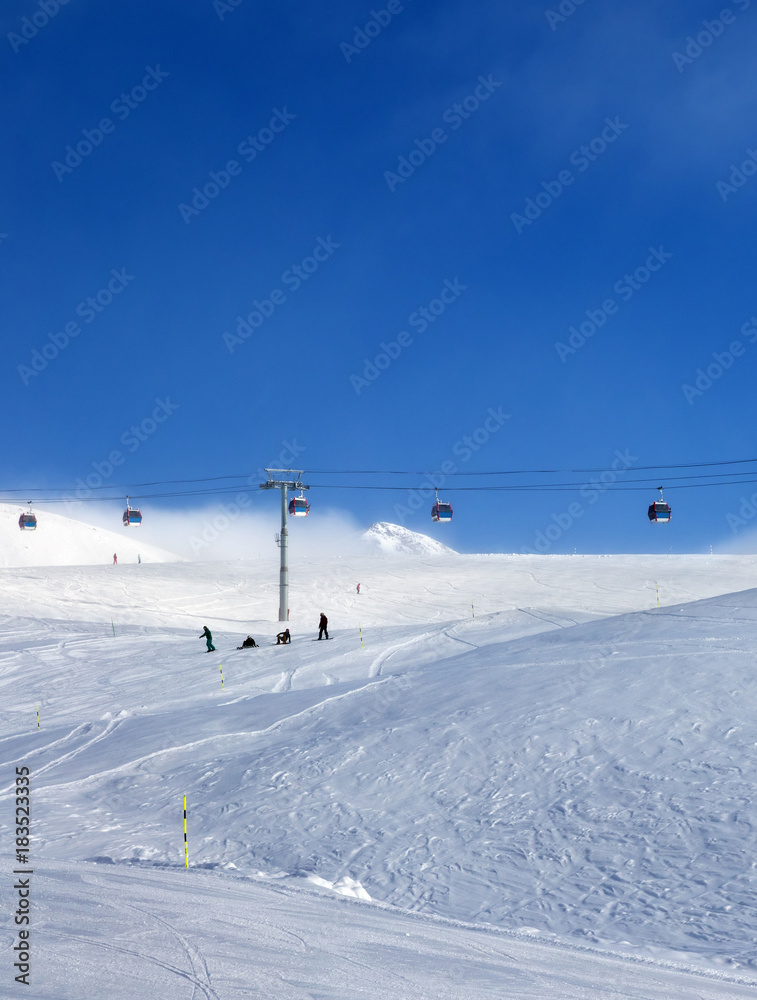 Gondola lift and snowy ski slope in fog Gondola lift and snowy ski slope in fog