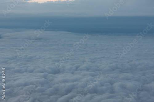View from airplane to white clouds