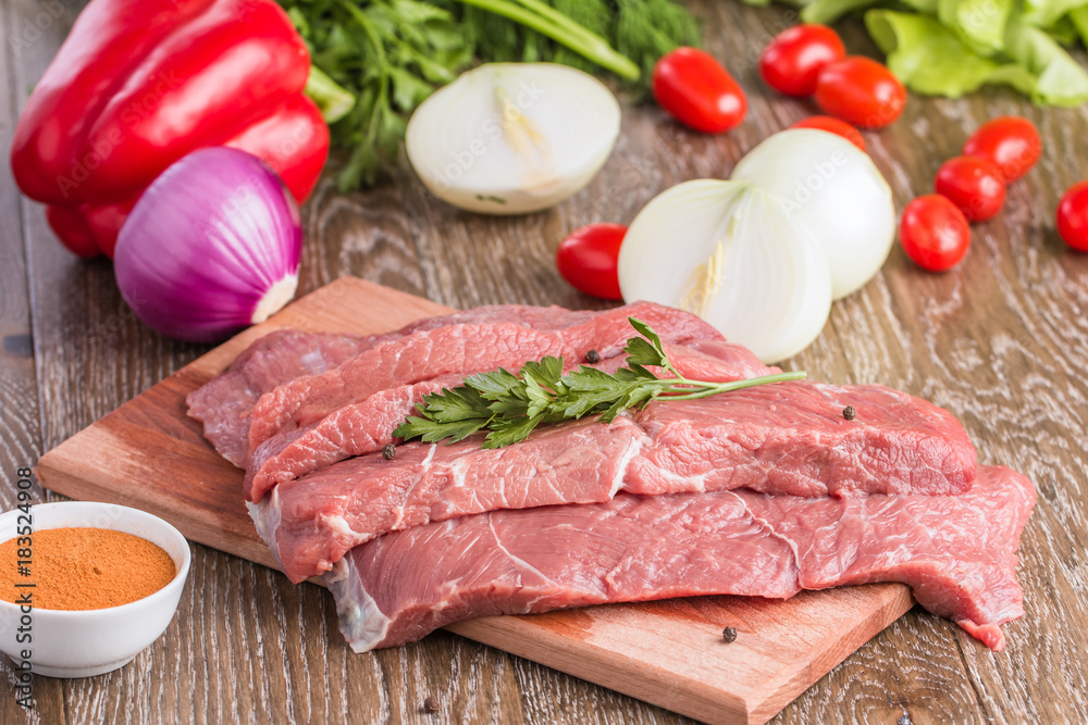 Cut of raw beef steak on wooden cutting board Cut of raw beef steak on wooden cutting board