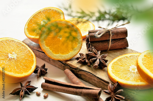 oranges with anisestars  cinnamon sticks and juniper branch