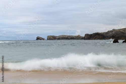 beautiful beach with waves breaking on the shore and without people 