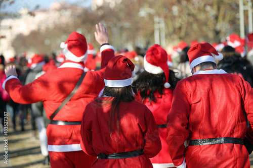 Картината върху платно many people with red dress of Santa Claus during a sport race