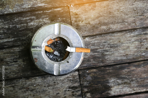 Cigarette with Ashtray on wood table