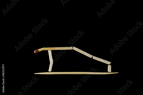 The man doing pushups. The figure of a man stilized by the matches. The objects are isolated and a clipping path is provided for easy extraction. photo