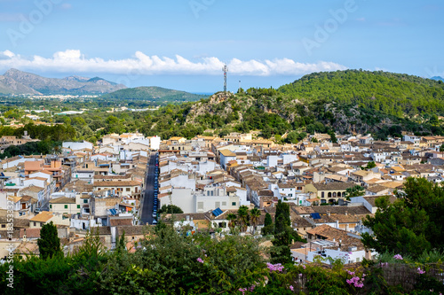 View of the city of Pollensa, Mallorca, downhill. Tops of roofs, straight streets, mountains. photo