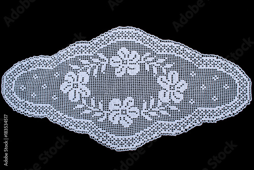 Beauty white oval lace tablecloth isolated on black background, floral pattern