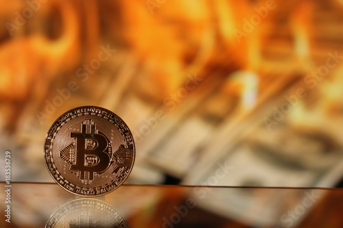 Bitcoin with blurred brinung dollas in the background photo