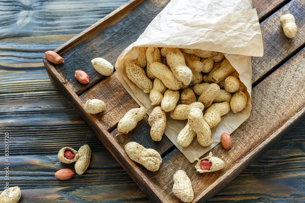 Paper bag with unshelled peanuts. Paper bag with unshelled peanuts.