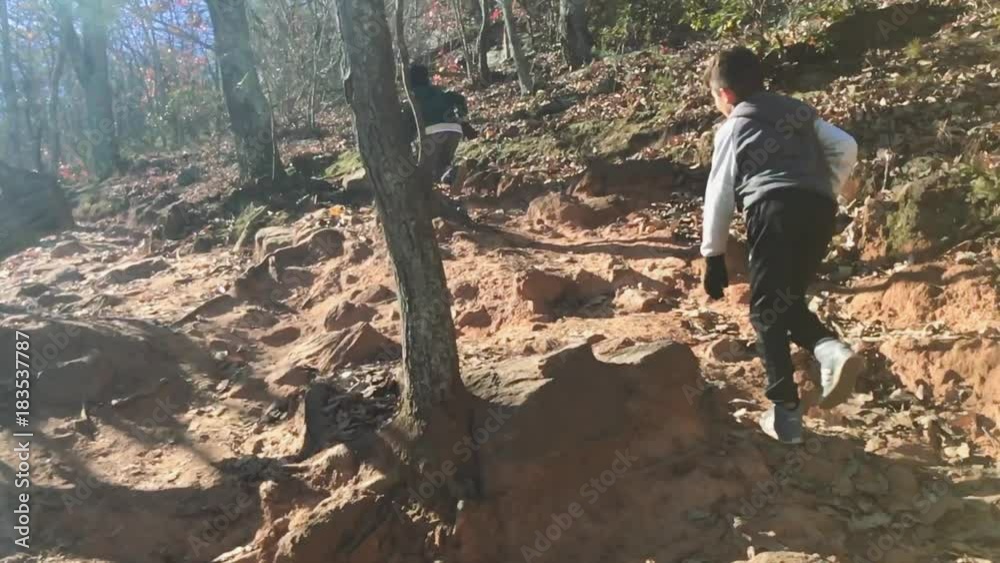 Great Slow Motion shot of two Kids hiking through rocky woods Great Slow Motion shot of two Kids hiking through rocky woods