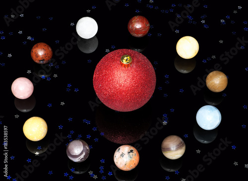 Fototapeta Naklejka Na Ścianę i Meble -  Christmas ball, semi-precious stones and stars on dark mirror background.