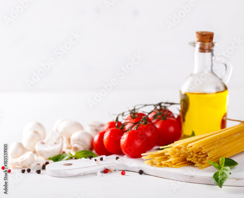 Pasta Spaghetti with ingredients for cooking pasta on a white background.Copy space for Text. selective focus.