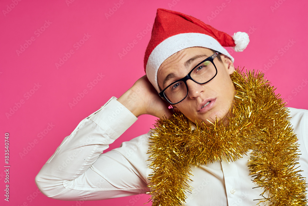 2127759 man in glasses and with yellow tinsel on his neck, portrait, pink background, new year 2127759 man in glasses and with yellow tinsel on his neck, portrait, pink background, new year