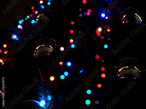 Christmas tree light. New year tree over black background