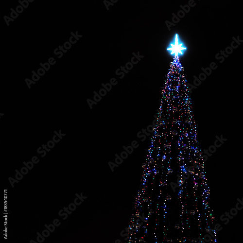 New year tree over black background. Christmas tree light