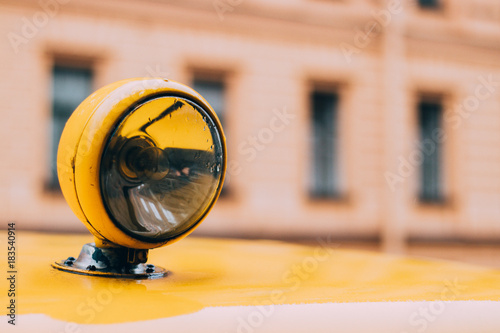 close up of a yellow flashlight on a car