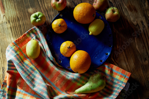 Citrus fruits on a blue plate. Contrast . Vitamins in case of sickness or vegetarianism