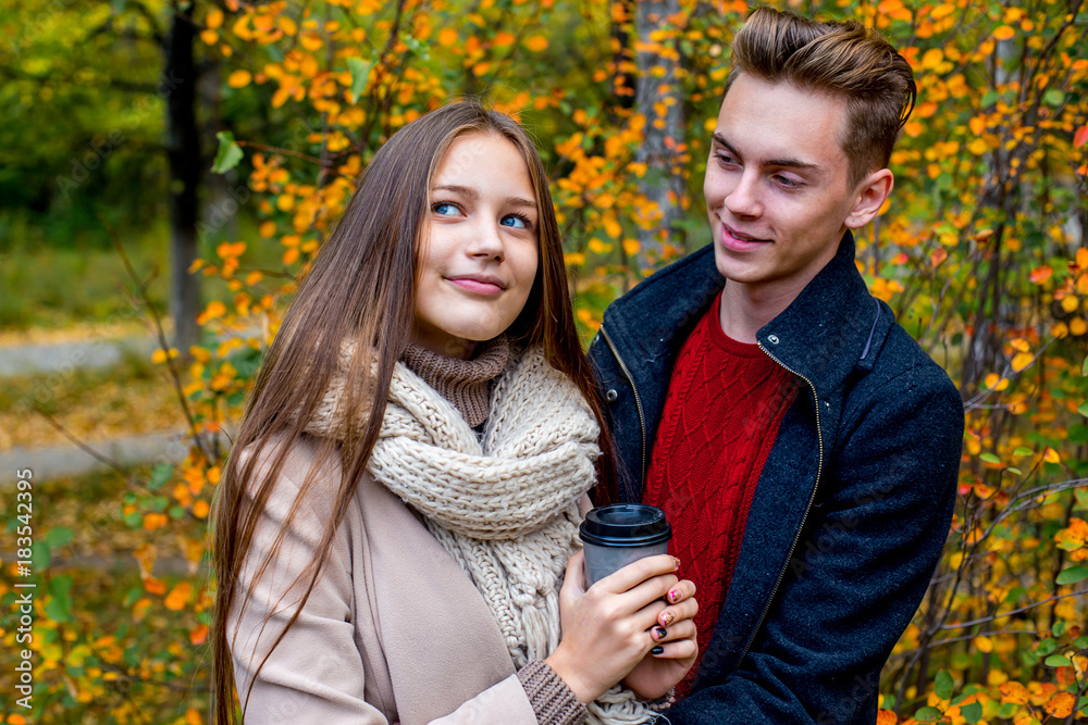 Couple walking in an autumn park Couple walking in an autumn park