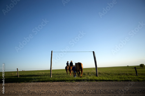 Cowboys heading out onto the range in the evening