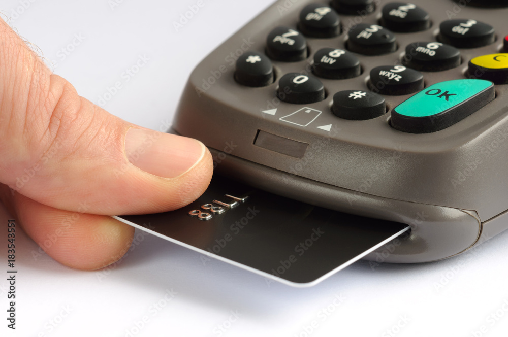 Paying with credit card. Man inserting chip card into payment terminal device Paying with credit card. Man inserting chip card into payment terminal device
