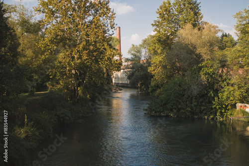 Adda river with linen mill in background to Fara Gera d'Adda