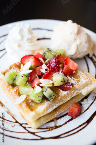 Waffles with fresh berries, whipped cream and ice cream