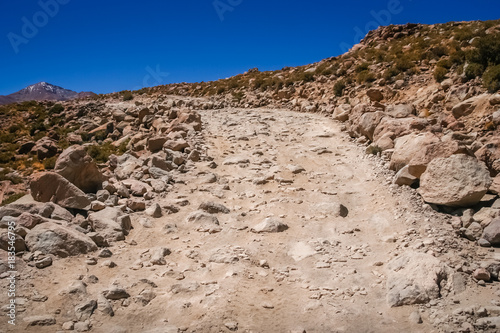 Mountain road formed of large rocks, stones and boulders