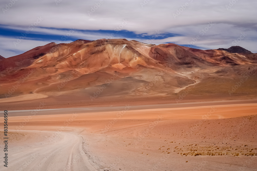 Fototapeta premium Sandy and gravel desert road through Altiplano